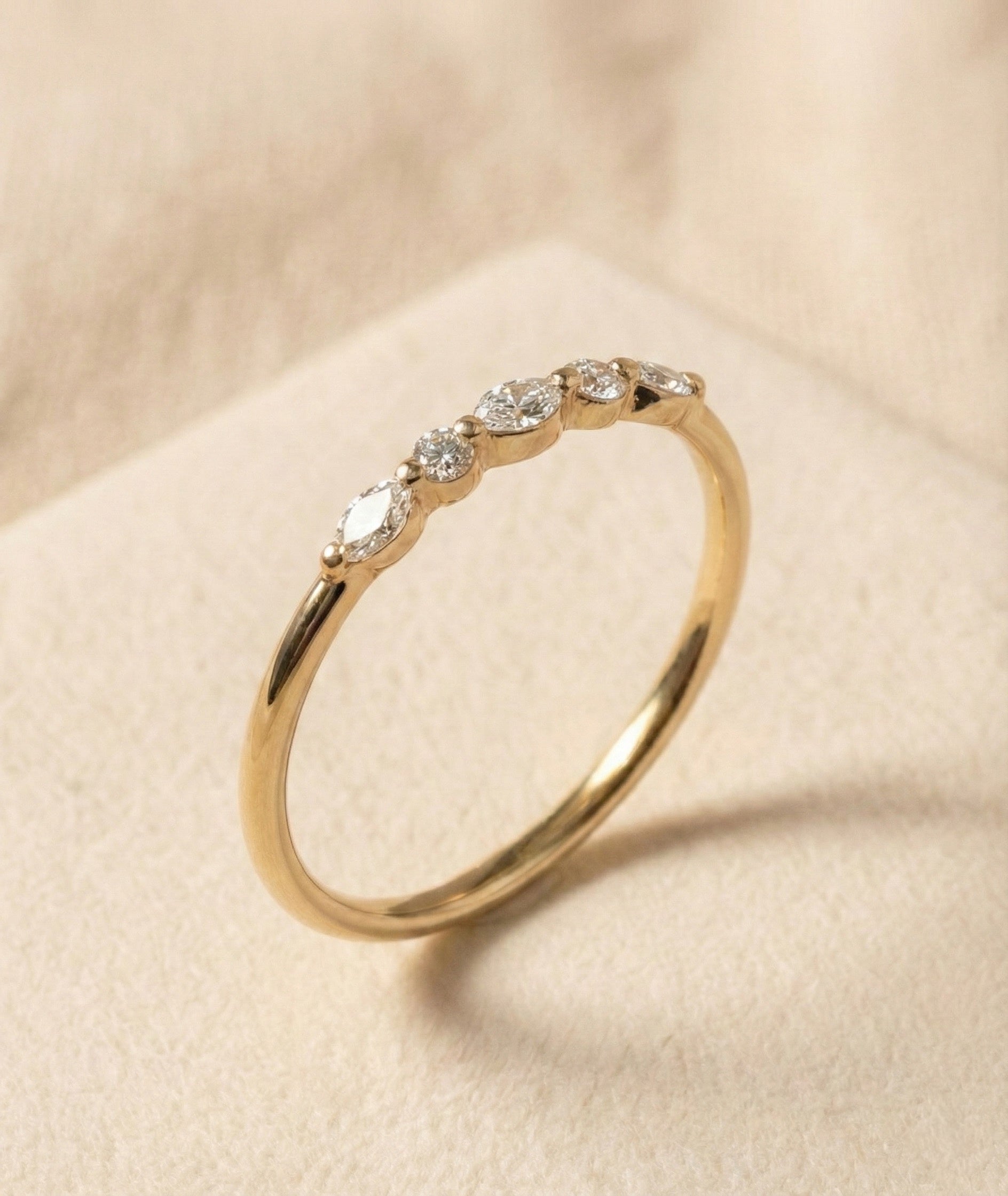 Handcrafted 14K gold ring featuring alternating marquise and round diamonds in a natural, leaf-like half-eternity pattern. Minimalist fine band, high-polish finish, elegant and lightweight design for everyday wear or stacking.