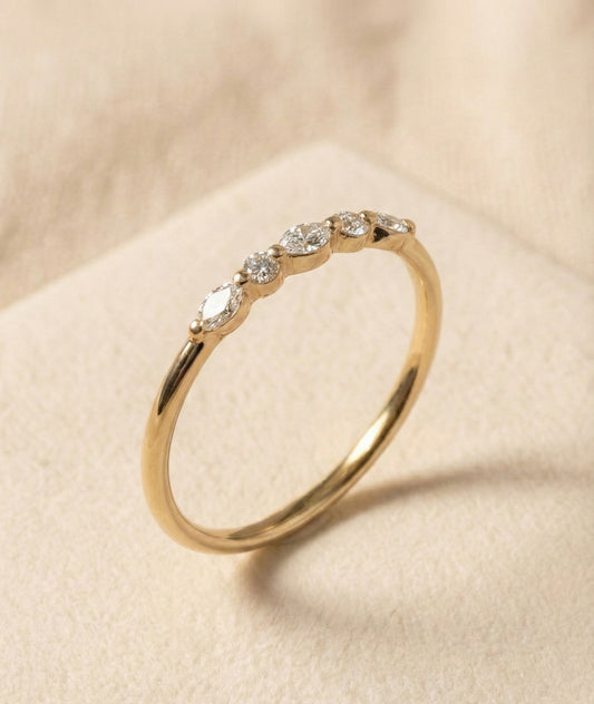 Handcrafted 14K gold ring featuring alternating marquise and round diamonds in a natural, leaf-like half-eternity pattern. Minimalist fine band, high-polish finish, elegant and lightweight design for everyday wear or stacking.