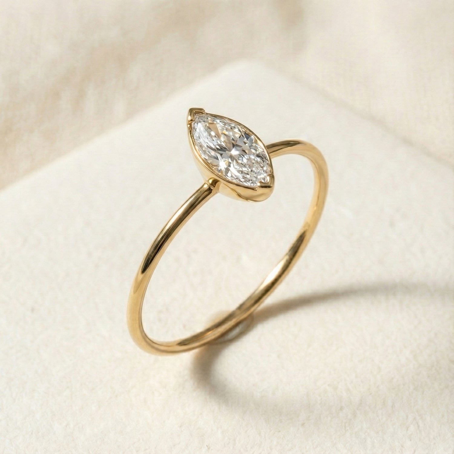Handcrafted 14K gold solitaire ring featuring a marquise cut diamond in an elegant, minimalist setting. Slim polished band, modern refined design ideal for engagement or everyday luxury wear.